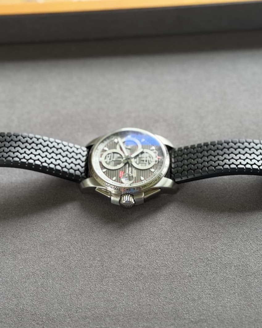 Low side view of the Chopard Mille Miglia GT XL on a tire-tread rubber strap